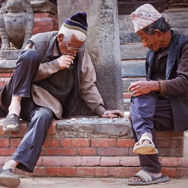 Two elders playing chess